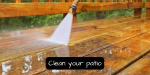 clening the patio using a garden hose with jet nozzle