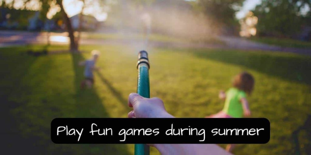 playing fun games in the summer with the kids using a gardening hose spraying water