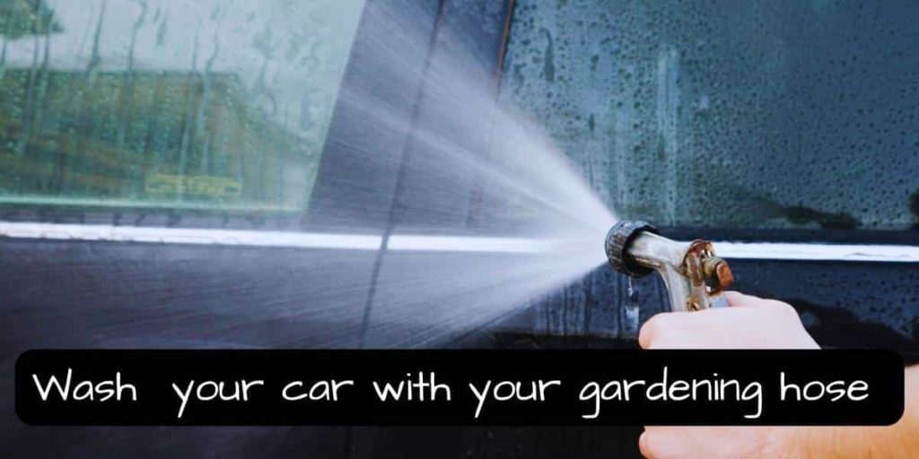 washing a car using a garden hose with jet nozzle