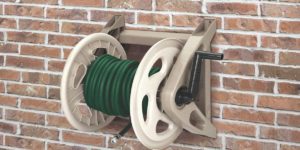 Hose reel mounted on a brick wall