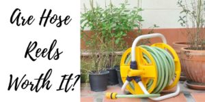 are hose reels worth it, yellow hose reel on the ground with a garden hose coiled